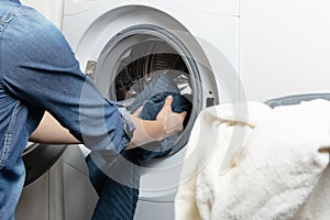 Cleaning and loading white washing machine