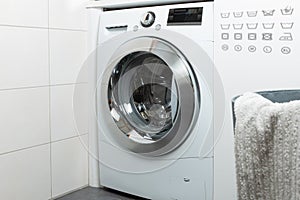 Cleaning and loading white washing machine