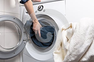 Cleaning and loading white washing machine