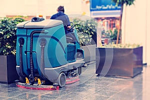 Cleaning machine for sanitation in the supermarket. Behind the wheel cleaner