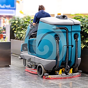 Cleaning machine for sanitation in the supermarket. Behind the wheel cleaner.