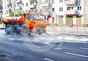 Cleaning machine washing the city asphalt road with water spray