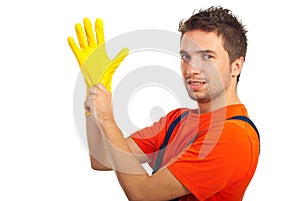 Cleaning man putting latex glove