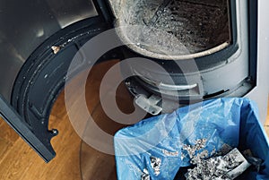 cleaning a modern fireplace from ashes, indoor shot, no people