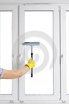 Cleaning modern PVC windows with a hand-held squeegee concept isolated on white