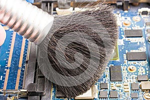 Cleaning the motherboard with a brush