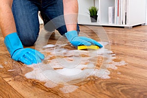 Cleaning a parquet floor with foam on the floor