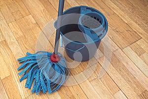 Cleaning parquet floor with rope mop