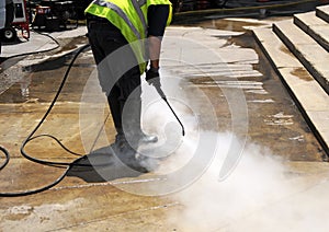 Cleaning the pavement of the street with pressurized water