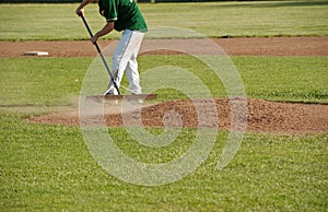 Cleaning the pitcher's mound after a game