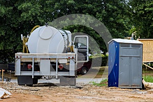 Cleaning portable restrooms with the help of a septic truck