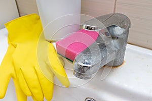 Cleaning products, agents gloves and sponge for washing dirty faucet with limescale, calcified water tap with lime scale on