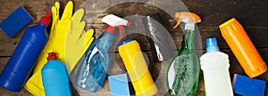 Cleaning products on wooden surface. House cleaning concept. Overhead view. From above.