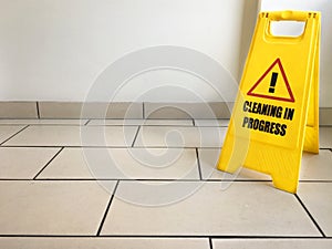 Cleaning in progress caution yellow sign on office floor