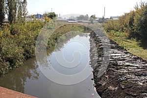 After cleaning the river the right bank is puddled with mud