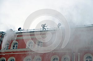 Cleaning the roof of a house in winter from accumulations of snow