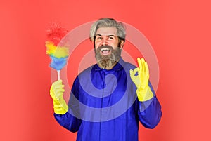 Cleaning service. Cleaning home concept. Small colorful duster broom. Housekeeping duties. Cleaning apartment. Man use