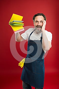 Cleaning service and household duty. Man in apron with gloves hold different sponges. Surface demand special care