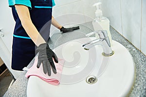 Cleaning service. wiping bathroom wash basin