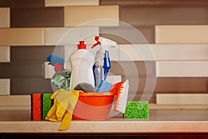 Cleaning set with products and supplies on kitchen table