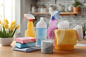 Cleaning set with products and tools on kitchen table