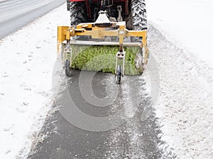 Cleaning sidewalk pavement with snowplow
