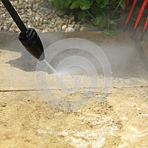 Cleaning the slabs of an outdoor terrace of a house with a karcher photo