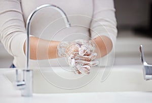 Cleaning, soap and washing hands in home bathroom for hygiene, safety or health for care in the morning. Skin, person