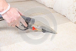 Cleaning the sofa with a vacuum cleaner in the time of dangerous viruses