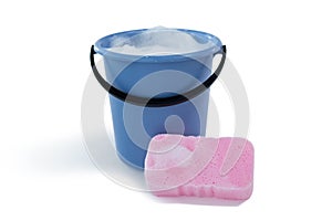 Cleaning sponge by bucket with soap sud photo