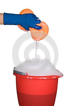 Cleaning sponge and bucket of soapy water photo