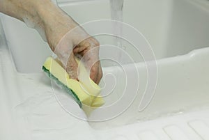 Cleaning with sponge scouring pad closeup photo