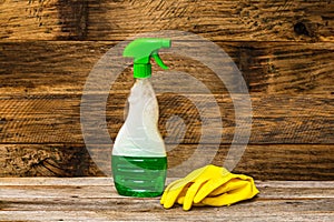 Cleaning sprayer anti bacterial sanitizer spray isolated with yellow gloves, concept of infection control.  Plastic bottle with