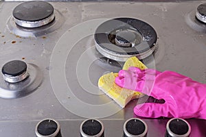 Cleaning of stainless steel gas stove with scrub and sponge