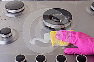 Cleaning of stainless steel gas stove with scrub and sponge