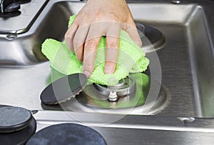 Cleaning stove top with microfiber cloth photo