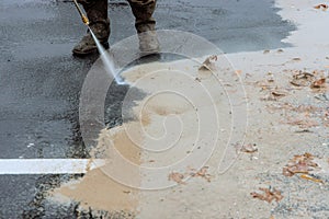 Cleaning a street with pressurized water, wet washing