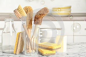 Cleaning supplies for dish washing and soap bubbles in kitchen