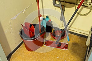 Cleaning supplies and tools arranged in storage place in a office