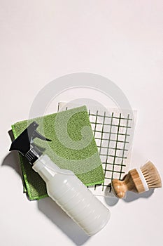 Cleaning supplies on white background, spray, brush and dishcloth, eco cleaning tools