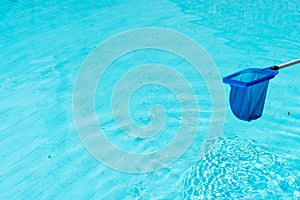 Cleaning of swimming pool with a net, with copy space in the water