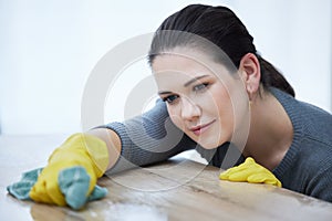 Cleaning, table and woman with cloth focus on washing furniture dust, dirt or bacteria for clean home, house or