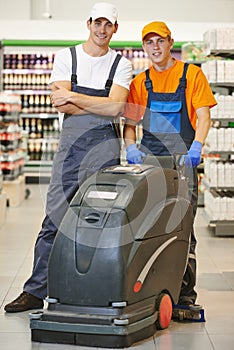 Cleaning team with machine in store