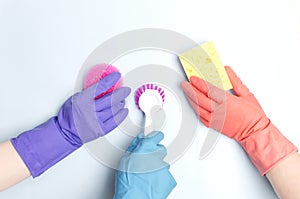 Cleaning team wearing protective gloves and holding different cleaning items to make clean your house.Concept of cleaning service