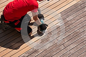 Cleaning the terrace with power sander, wood boards before and after sanding