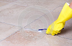 Cleaning tile grout with toothbrush