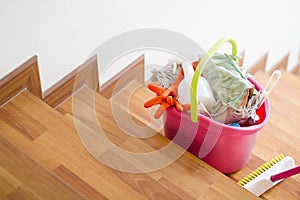 Cleaning tools in bucket on stair are prepare to cleaning whole house