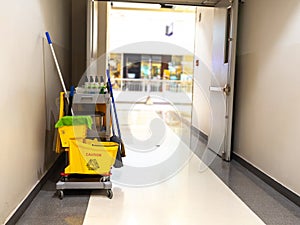 Cleaning tools cart wait for maid or cleaner in the department store. Bucket and set of cleaning equipment in the mall. Concept of