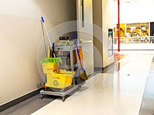 Cleaning tools cart wait for maid or cleaner in the department store. Bucket and set of cleaning equipment in the mall. Concept of