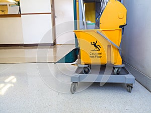 Cleaning tools cart wait for maid or cleaner in the hospital. The warning signs cleaning in process the floor in building. Bucket